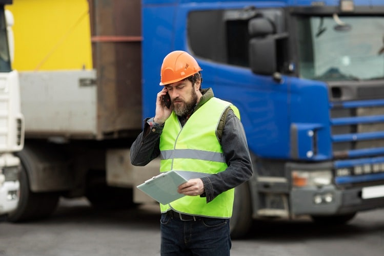 Logistics coordinator arranging same day delivery collection with heavy goods vehicle